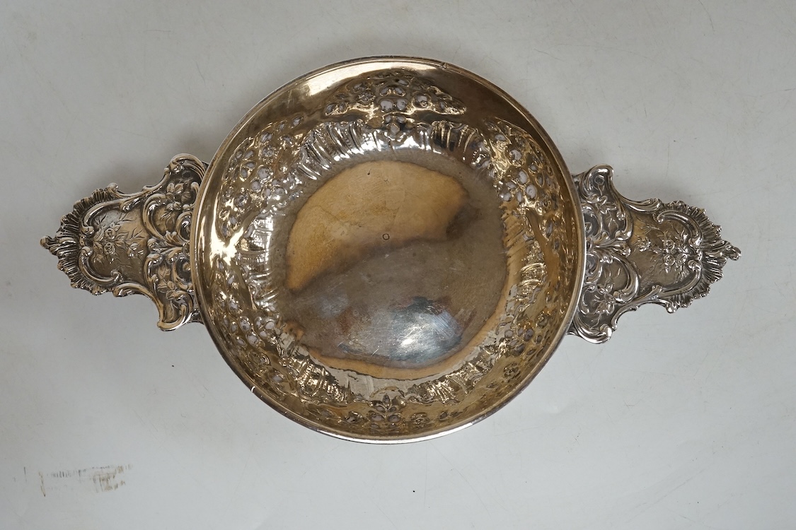 An early 20th century French 950 standard white metal taste vin, embossed with foliage, 20cm, over handles, 4.5oz.